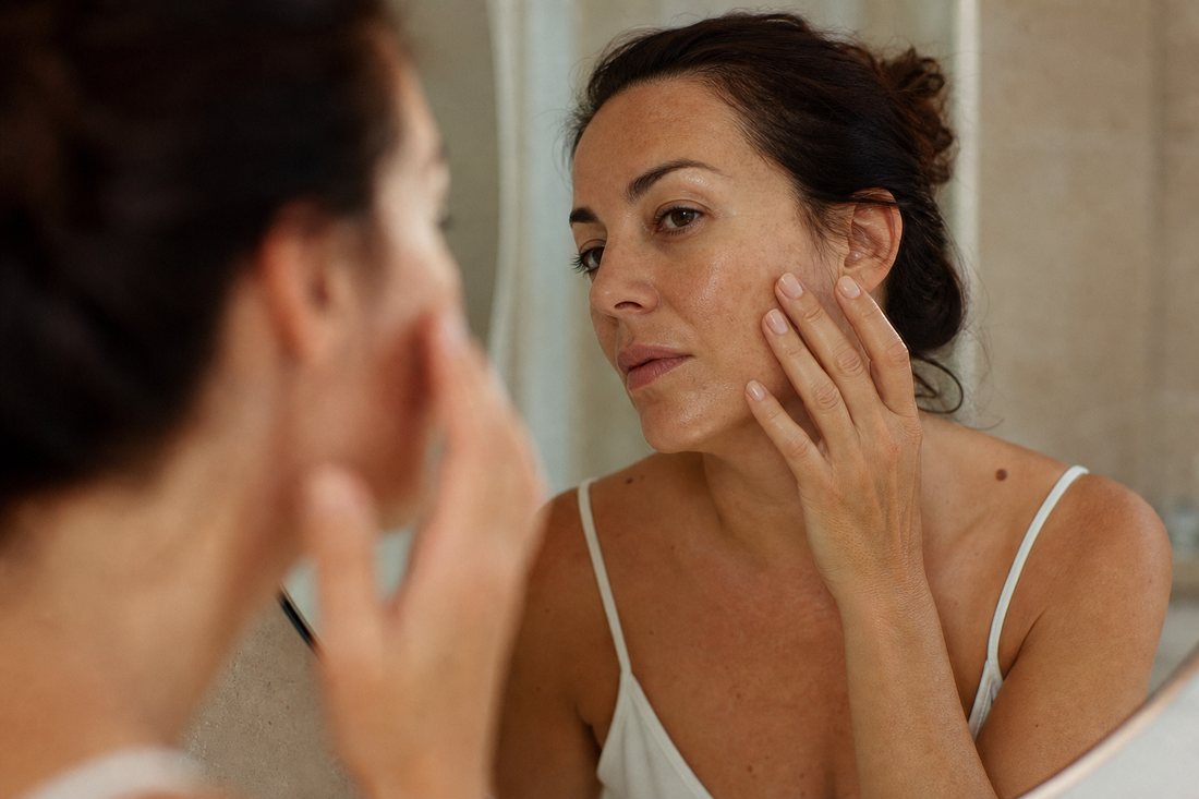 Woman examining dark spots in the mirror